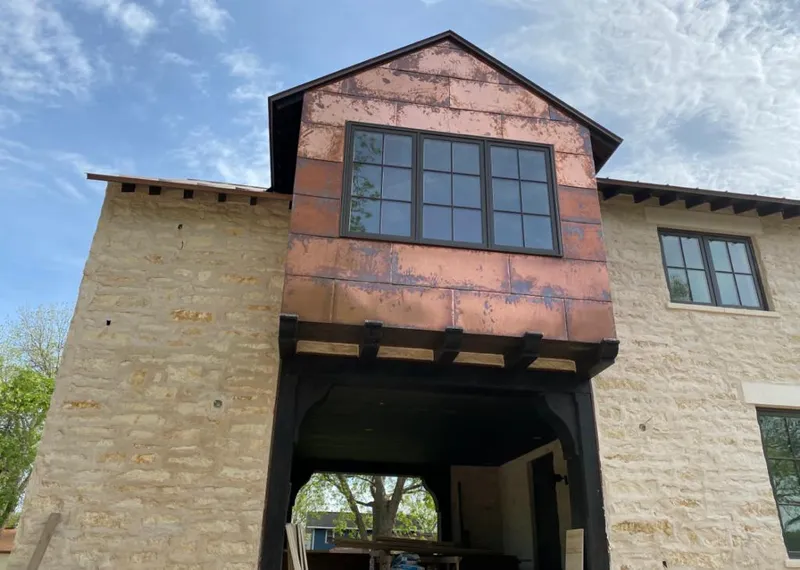 Copper metal panel facade on a stone building for Metal Roof Coating in Audubon